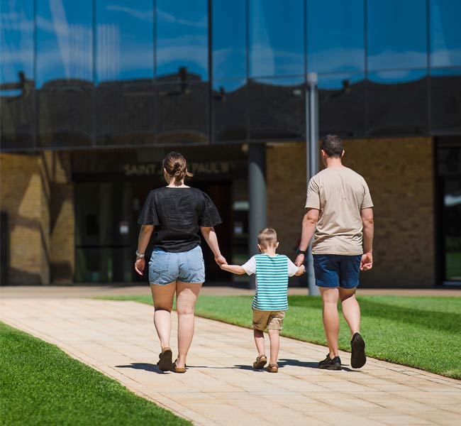 Veteren walking holding hands with family.