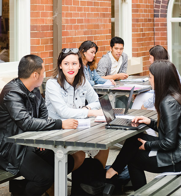 Students sitting at table.