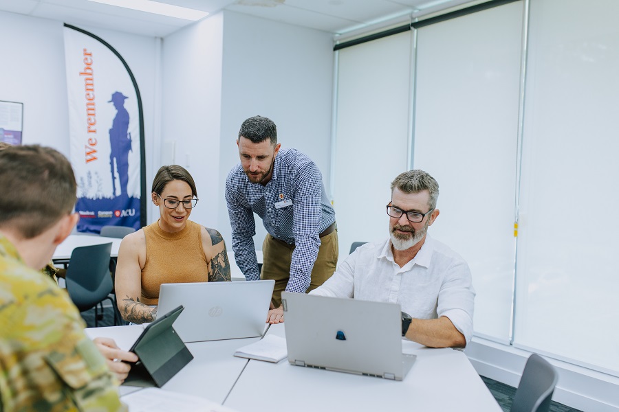 photo of people with laptops working together